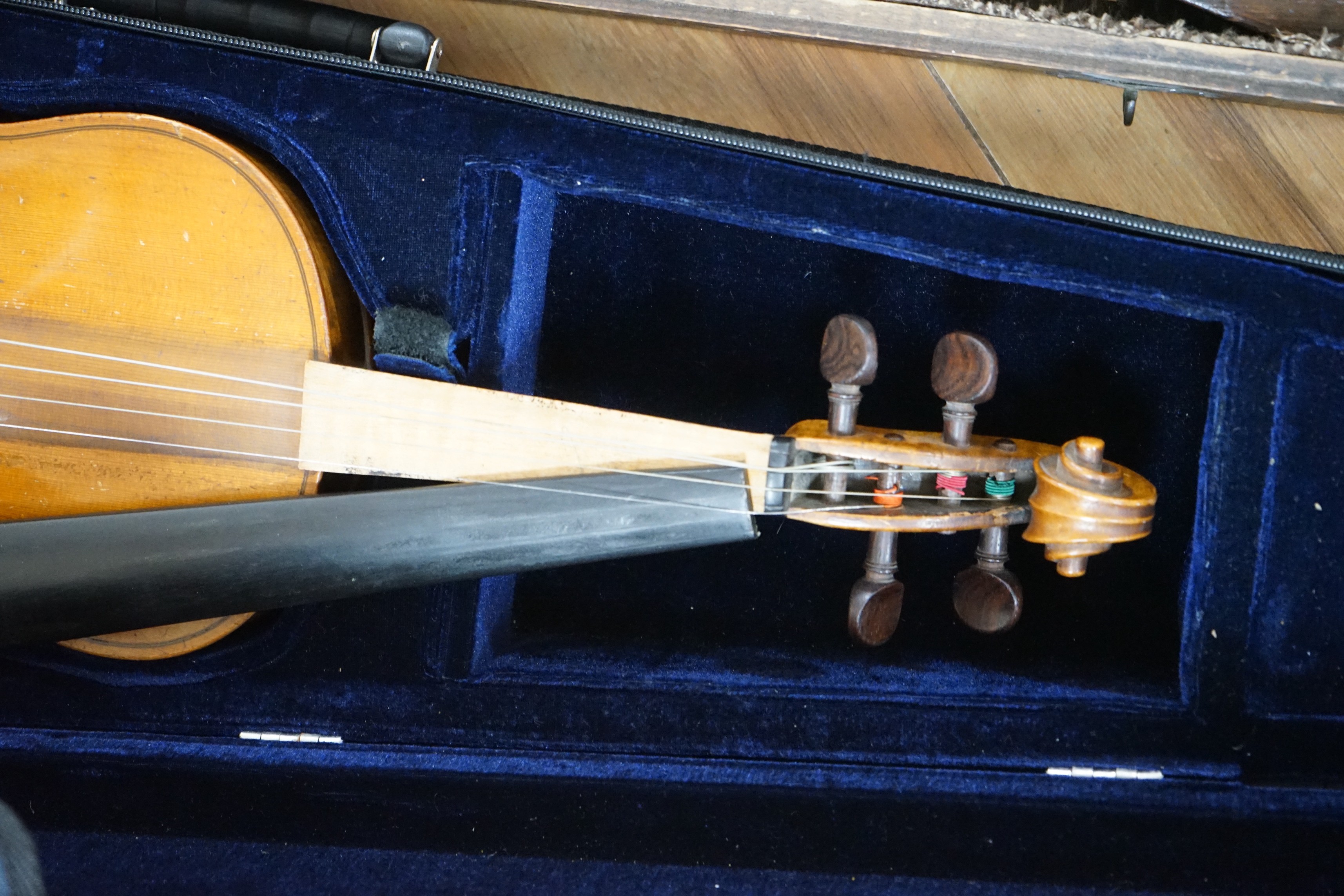 Two cased unnamed violins